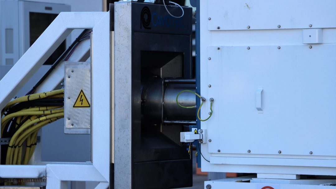 Nærbilde av industrimaskiner med kabler og elektriske fareskilt ved Oslo havn. Et ingen oppføring-symbol er synlig nederst til høyre.