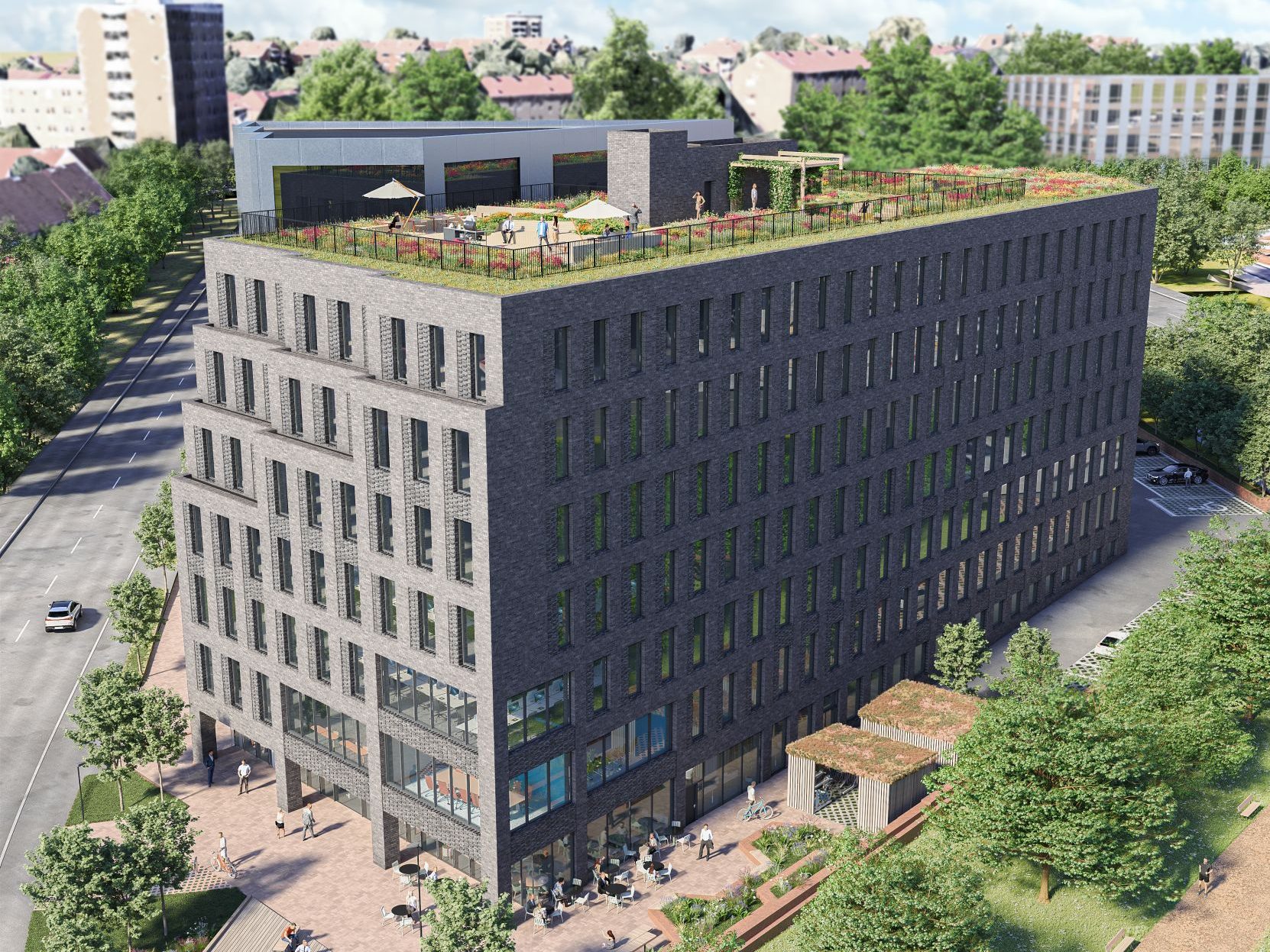 Et moderne kontorbygg i flere etasjer med grønt grep, med en grønn takterrasse. Det er omgitt av trær og grenser til en vei med parkerte biler.